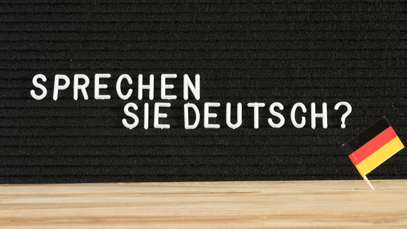Notice board displaying the words 'Sprechen Sie Deutsch?' and a little German flag.