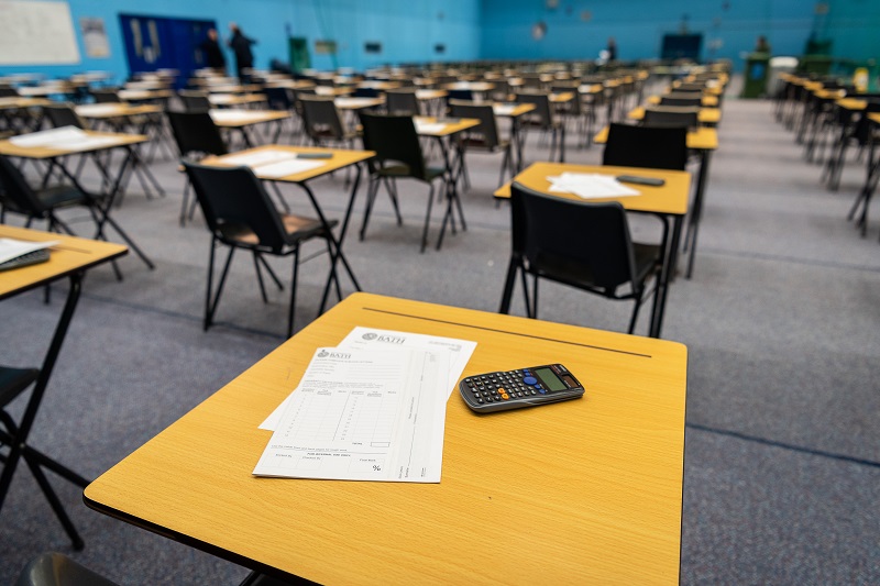 Lines of desks and chairs in an exam hall at university.