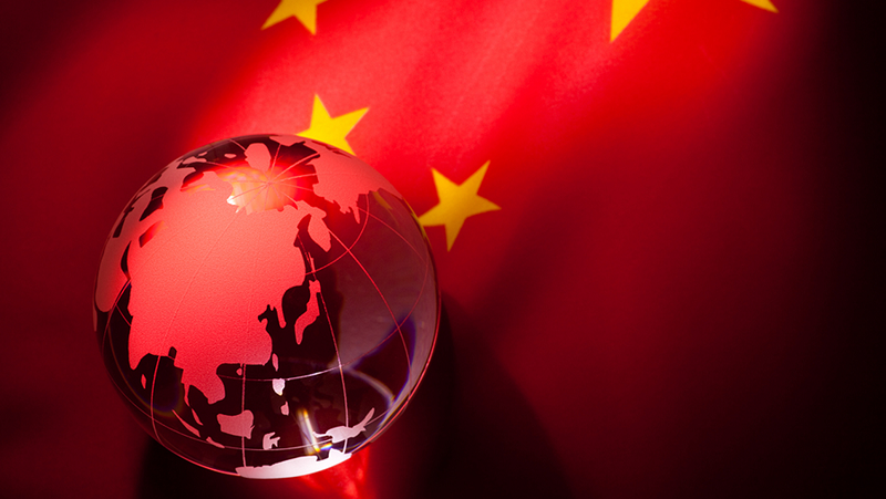 A Chinese flag with a globe showing China
