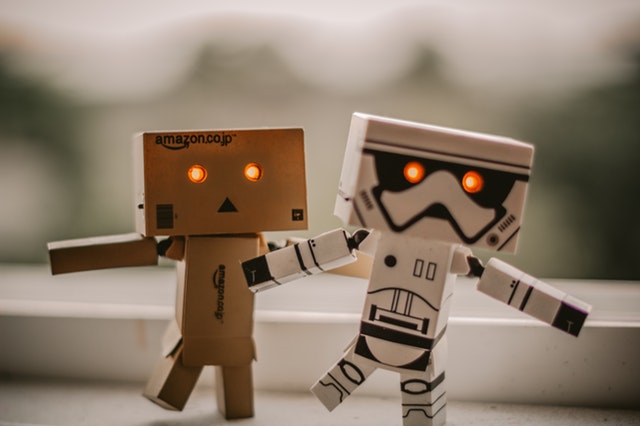 Image of two small robots with glowing red eyes