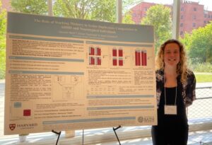 Student standing alongside large poster