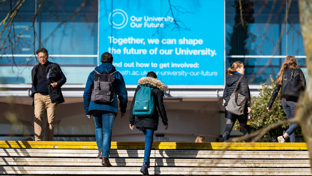 People walking up steps towards the University of Bath's main parade. 