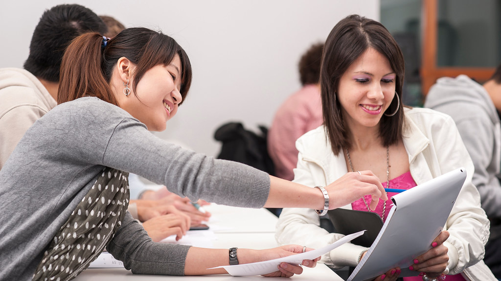 Two people working together using a laptop.