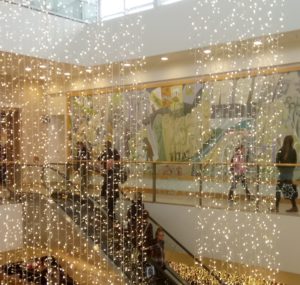 Christmas lights sparkle over an escalator
