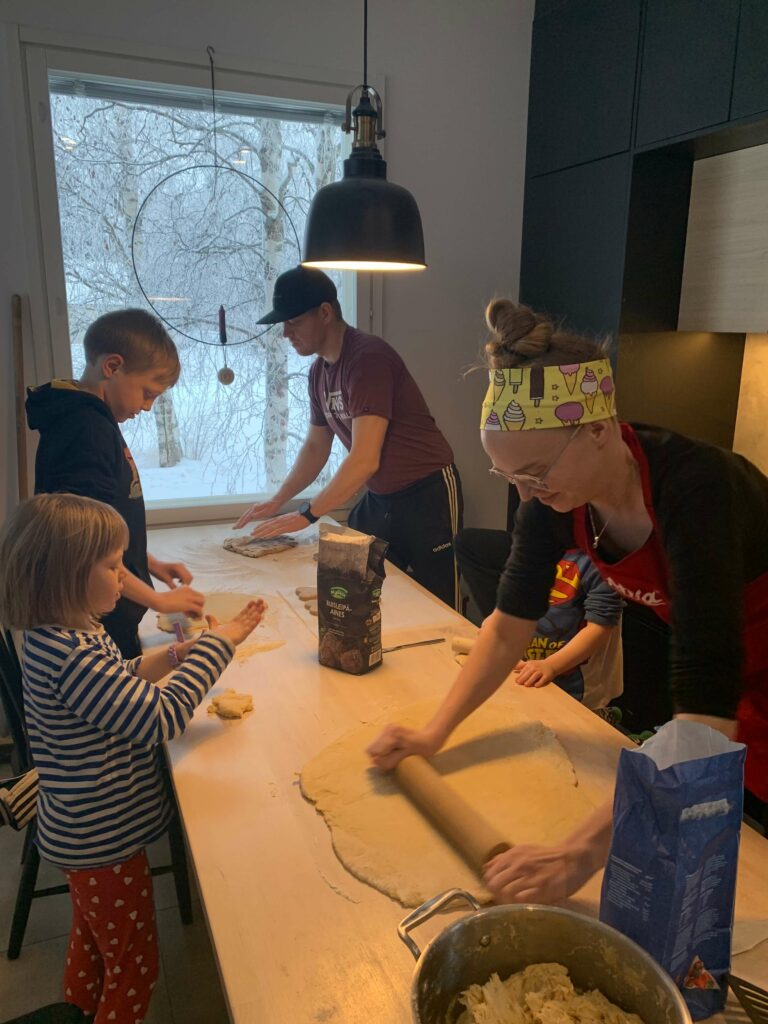 A Finnish family making food together around the table