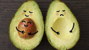 Two avocado images as cartoons to show one with a baby bump looking happy and one without looking sad