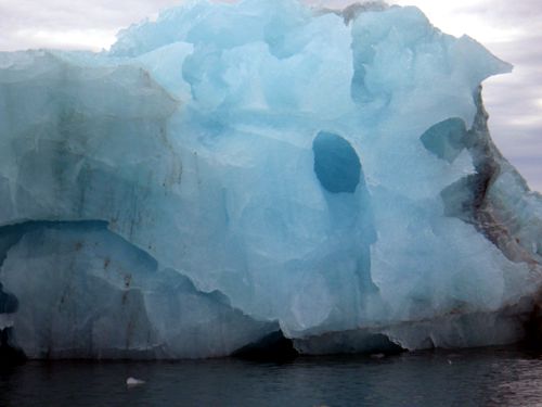 A typical blue iceberg, calved from the bottom of the glacier. It is around 3 m high above the water: there is 80% more below the water line ...