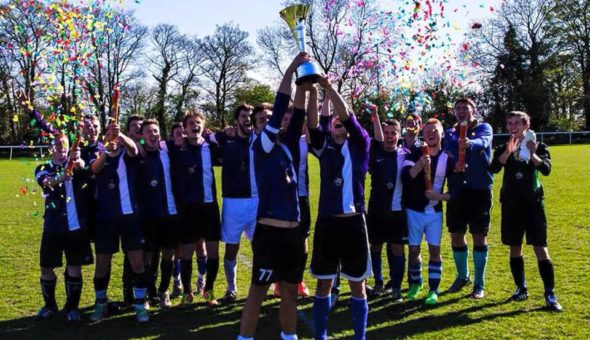 The winning IDFC team stood up celebrating their win with the trophy held aloft and confetti overhead
