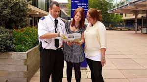 A security guard guiding two women in the right direction