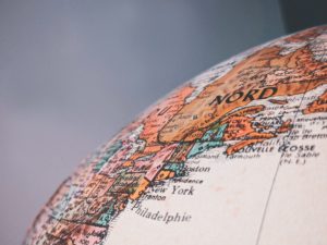 A quarter of a globe with a grey background
