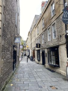 Cobbled street with cobbled buildings on either side of it.