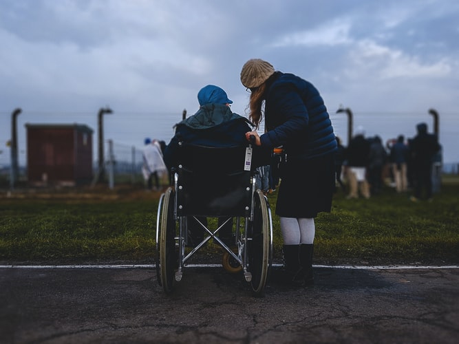 Two women, one in a wheelchair talking.