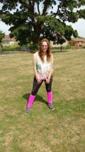 Myself at a colour run with leg warmers and a fluffy boa. 