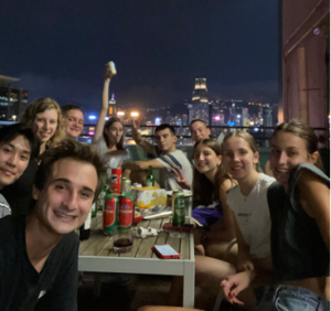 Image showing a group of students at a party round a table on a terrace