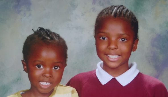Me and younger sister posing for primary school photo