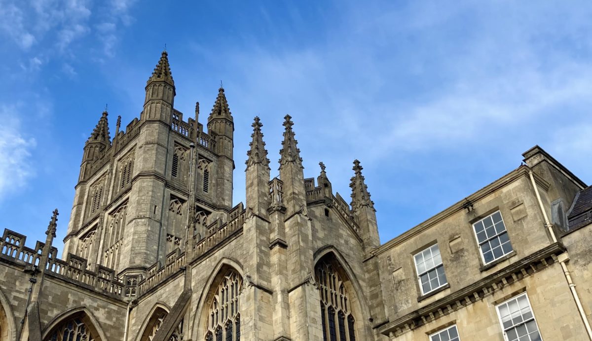 Photo of Bath Abbey under a blue sky.