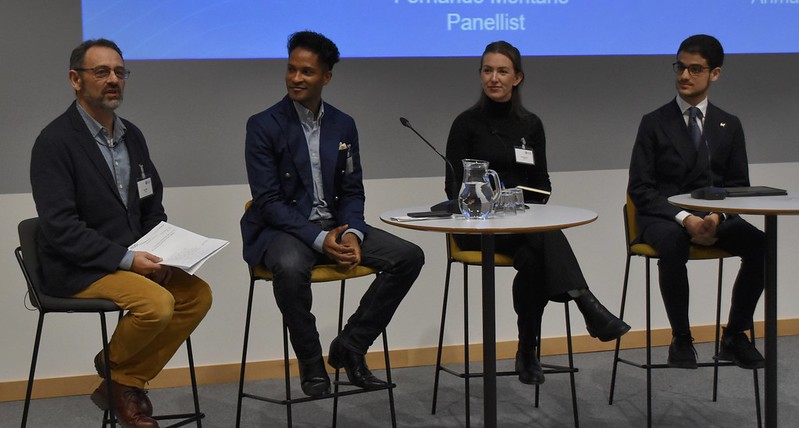 A photo of panel members from the One Young World Bath caucus, they are sat on stools with microphones talking to the audience.